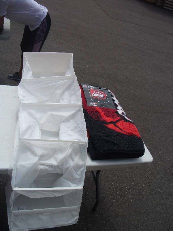 lot 47 image: Brand New Sherpa Throw (Buccaneers) & Closet Rod Organizer