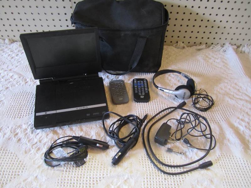 lot 12 image: Audiovox DVD Player with accessorie...