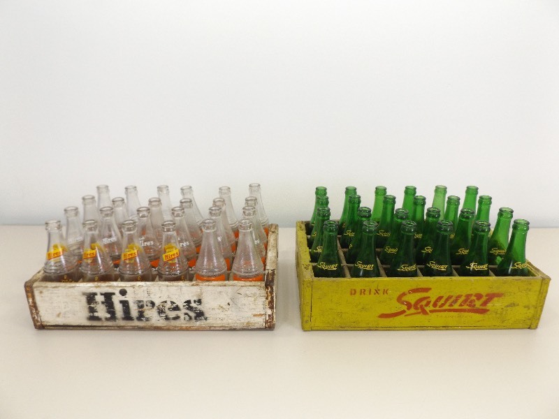 lot 27 image: 2 Vintage Hires Root Beer and Squirt Crates with 48 Bottles