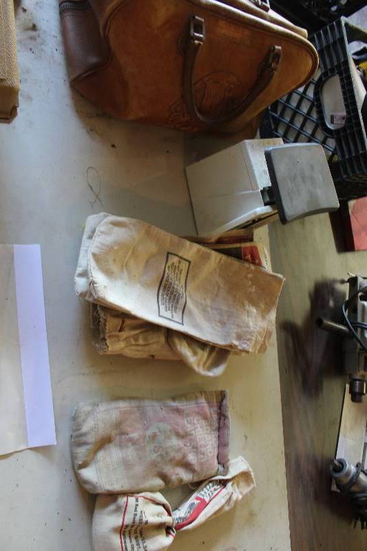 lot 74 image: 1965 Leather Sioux Indian Shoot Bag, Shooting Safety Glasses, 1.5 Bags of Shot, Approximately 10 Empty shot Bags