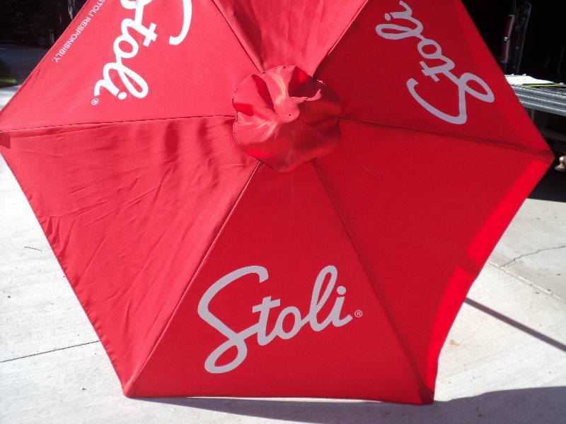 lot 19 image: stoli red umbrella 80in diameter, 7...