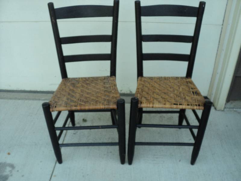 lot 52 image: 2 black chairs with woven seats...