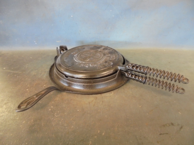 lot 91 image: Griswold Cast Iron Waffle Iron with Base