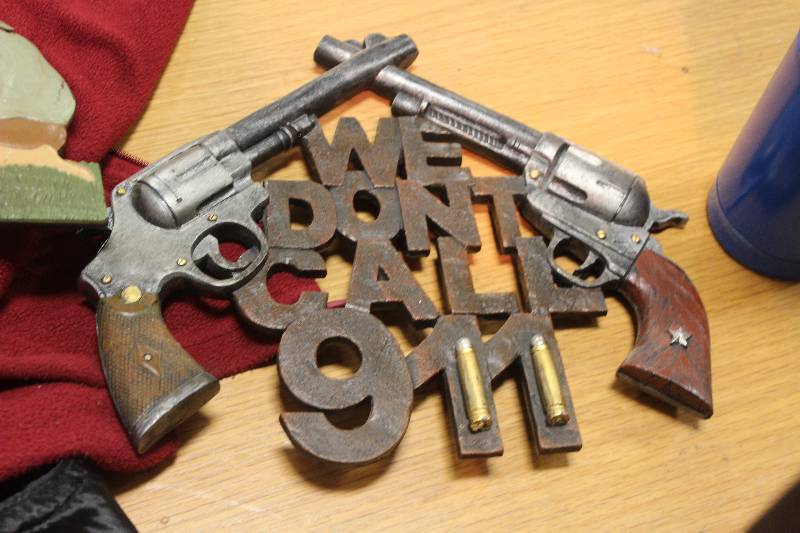 lot 112 image: We Dont Call 911 Metal Wall Art