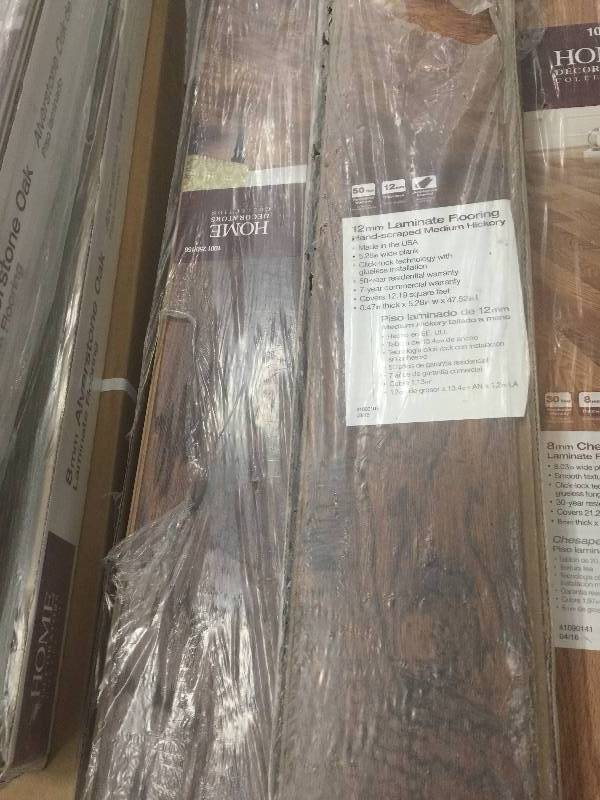 lot 7 image: Home Decorators Collection Hand-Scraped Medium Hickory 12 mm Thick x 5-932 in. Wide x 47-1732 in. Length Laminate Flooring (12.19 sq. ft.  case)  9 cases open boxnever used Model # 368301-00256