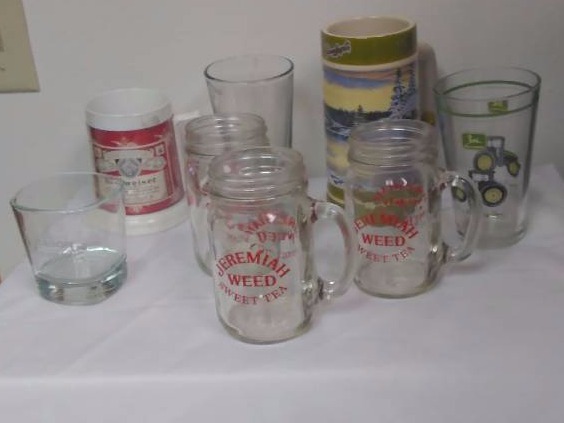 lot 17 image: Man Cave Collector Glasses (7) Jerimiah Weed Sweet Tea (3), John Deer, Leinenkugels, Budweiser, Jack Daniels
