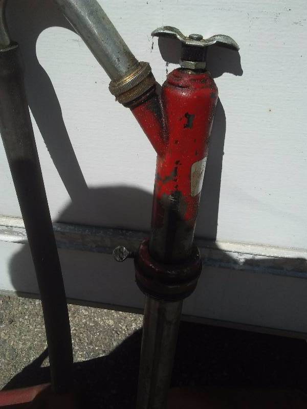 lot 107 image: Gas Cans and Oil Pump Dispenser, 5 gal and 2  gal.