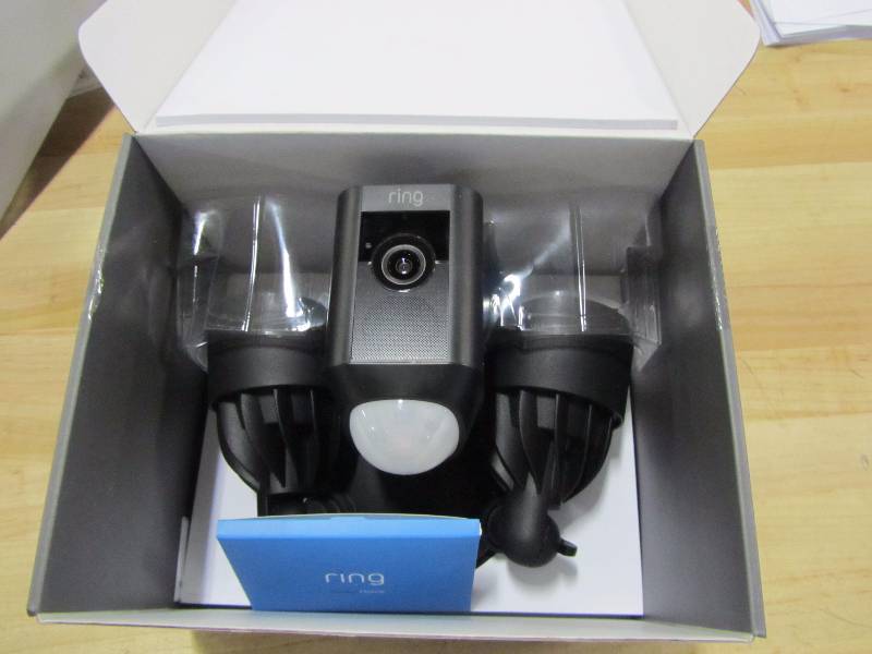 lot 53 image: Ring Outdoor Wi-Fi Cam with Motion Activated Floodlight, PLEASE READ This Item is black not white