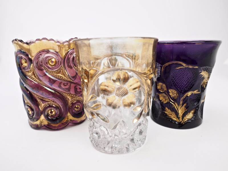 lot 61 image: EAPG S-Repeat Spooner, Cambridge Near Cut Thistle Amethyst w Gold Tumbler, and Floral w Gold Tumbler
