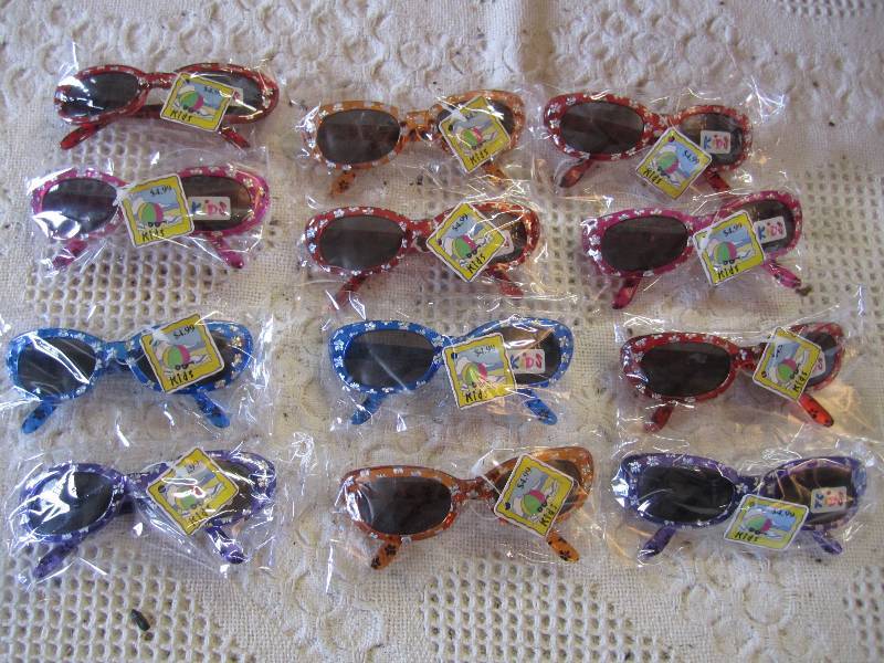 lot 80 image: Lot of 12 kids sunglasses in packag...