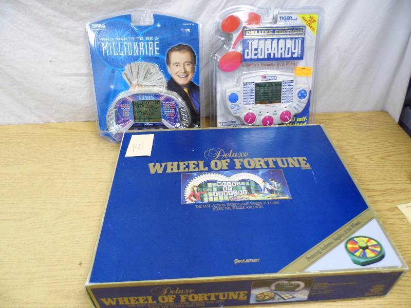 lot 141 image: 2 New Handheld Games & Wheel of Fortune