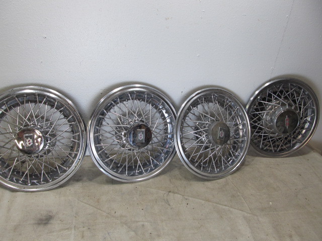 lot 36 image: Lot of 4 Vintage Hubcaps