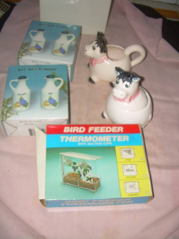 lot 34 image: COW SUGAR AND CREAMER , 2 SETS OIL AND VINIGERS , BIRD FEEDER THERMOMETER