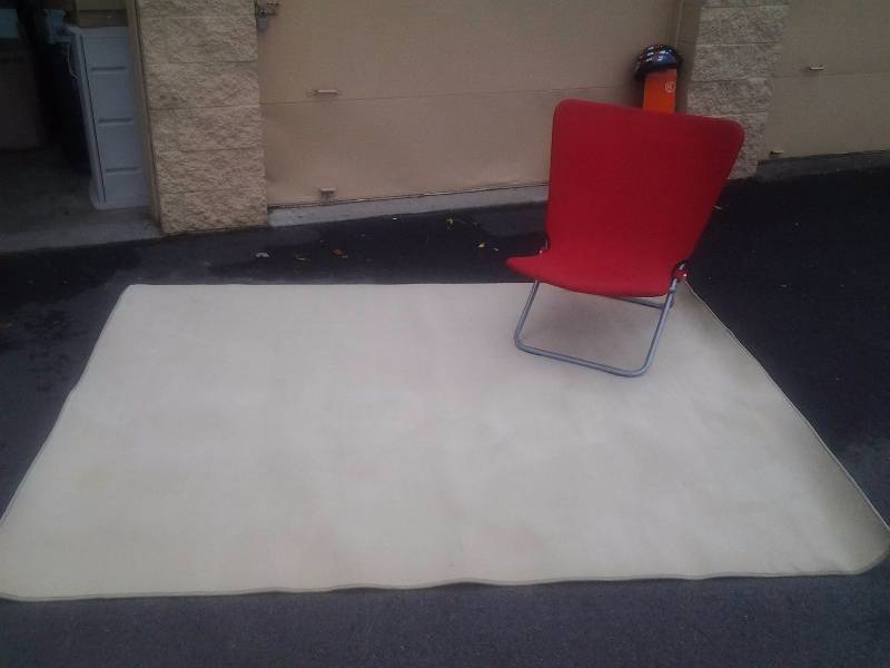 Tan Rug & Red Folding Chair