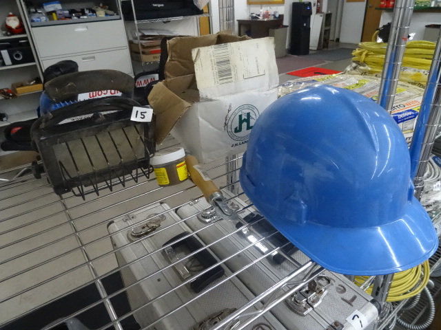 Box of hinges. Hard hat. Halogen sh...