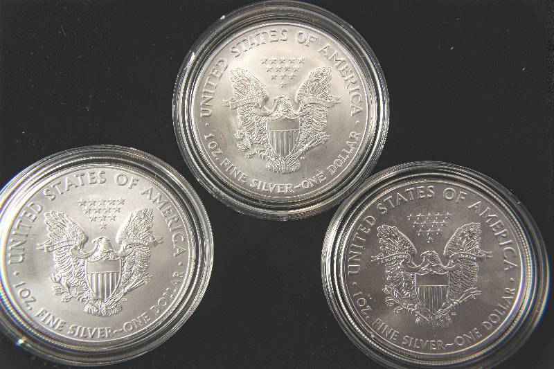 lot 101 image: GROUP OF 3 SILVER AMERICAN EAGLES IN AIRTITE HOLDERS  2003, 2013 & 2016