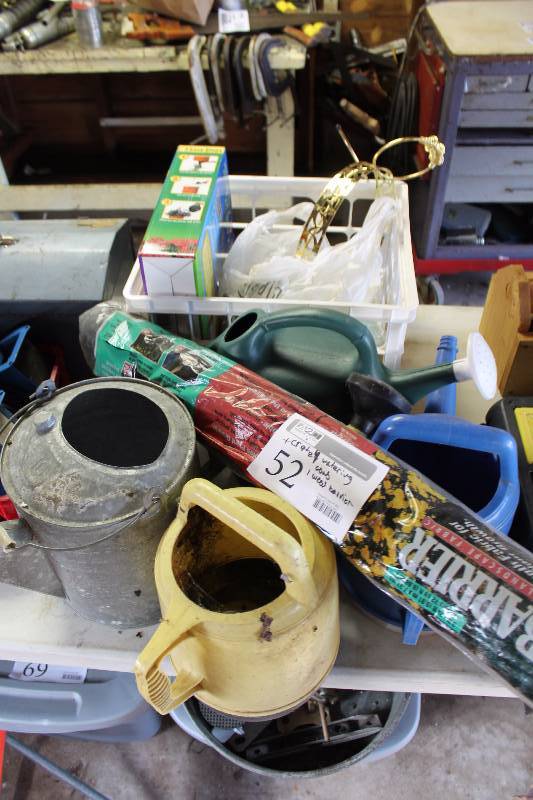 lot 52 image: Crate Lot of Gardening Supplies Includes 4-Water Cans, 1-Roll Weed Barrier