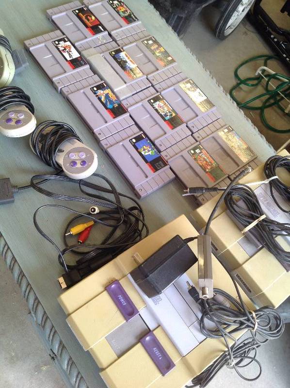 lot 31 image: 2 super nintendo systems with 11 games and 3 controllers