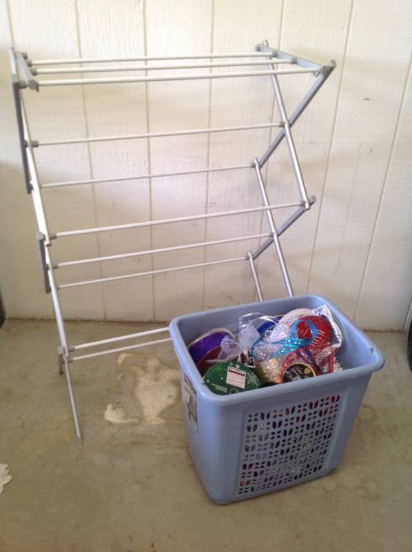 lot 40 image: Folding drying rack and cloths hamper full of Holiday ribbon