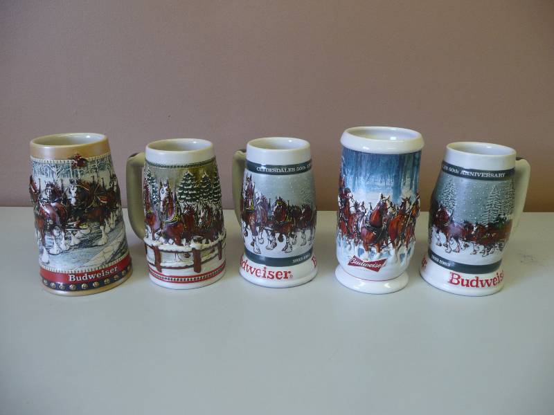 lot 73 image: (2) 1983, (1)1984,(1)1988 & (1)2007 BUDWEISER HOLIDAY STEINS - GREAT CONDITION SEE PICTURES