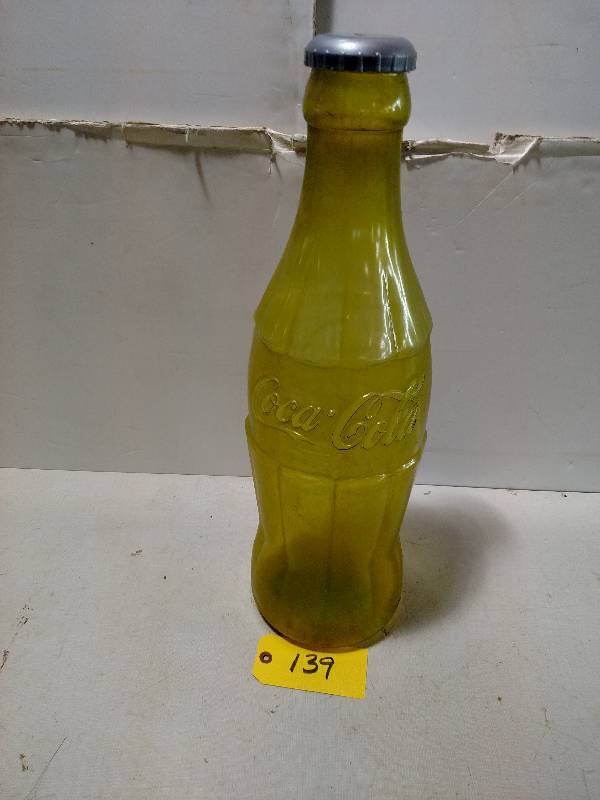 lot 139 image: Plastic Coca-Cola Bottle Bank