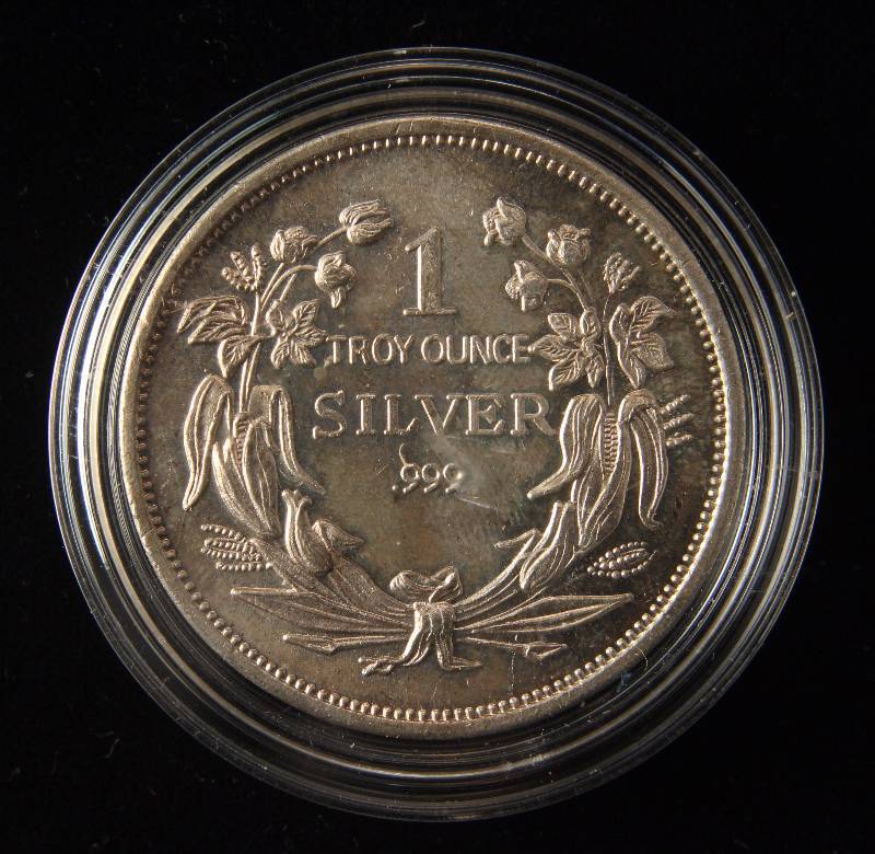 lot 24 image: 1 TROY OZ. .999 FINE SILVER SEATED DOLLAR DESIGN IN AIRTITE HOLDER