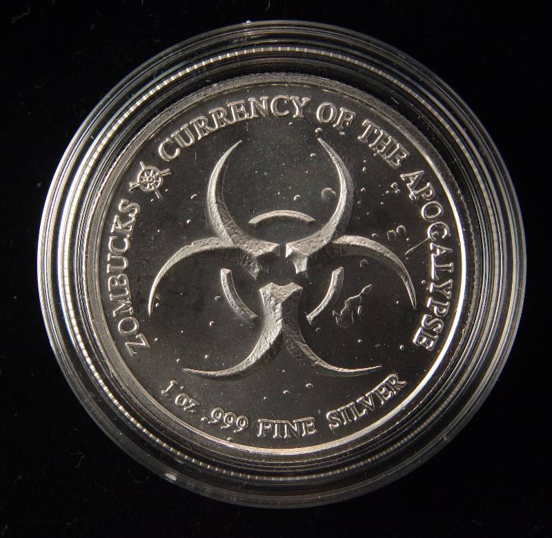 lot 28 image: 1 TROY OZ. .999 FINE SILVER ZOMBUCKS 2019 THE SAINT IN AIRTITE HOLDER