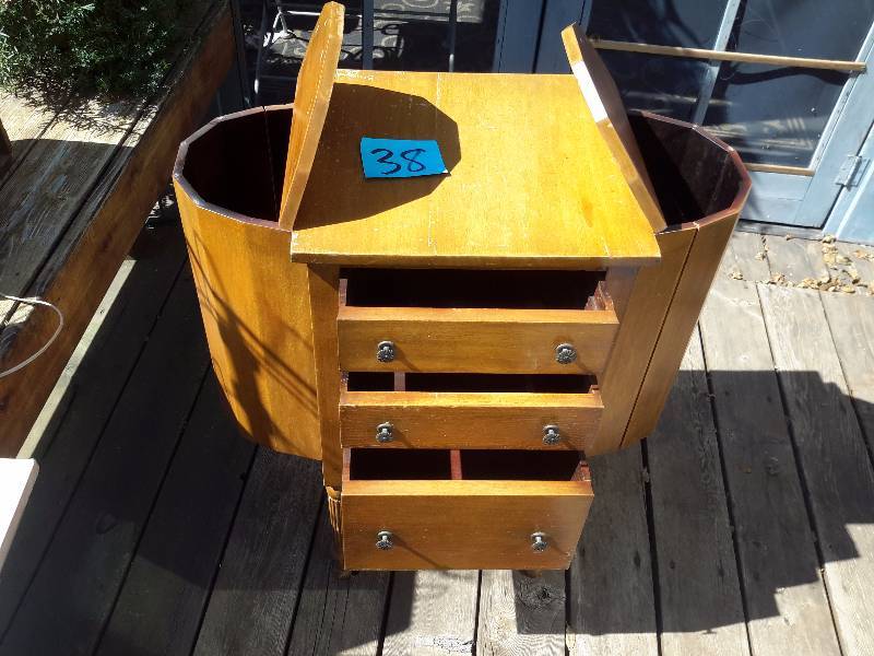 Vintage Sewing cabinet with top feed storage on sides and 3 drawers�