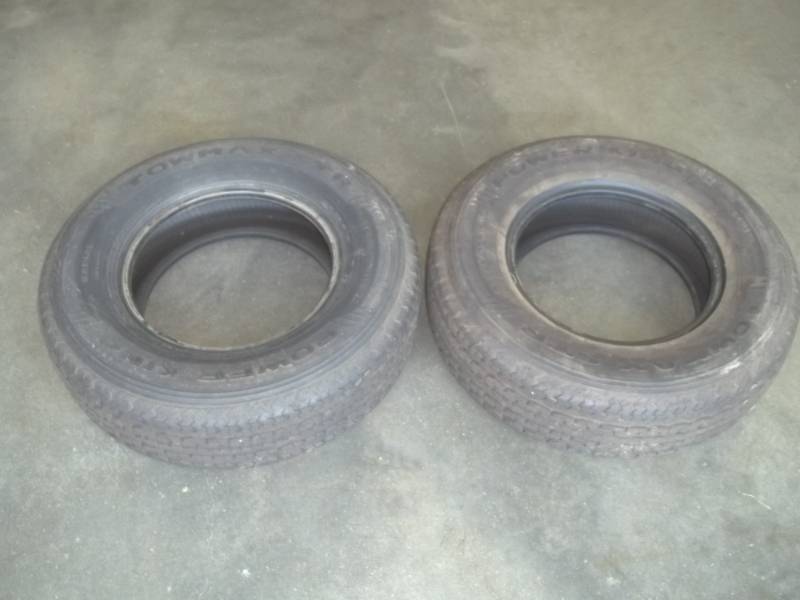 lot 21 image: 2 matching campertrailer tires. Power King Towmax STR.  ST22575R15.  8 Ply steel belted. Consignor  said less than 300 miles.