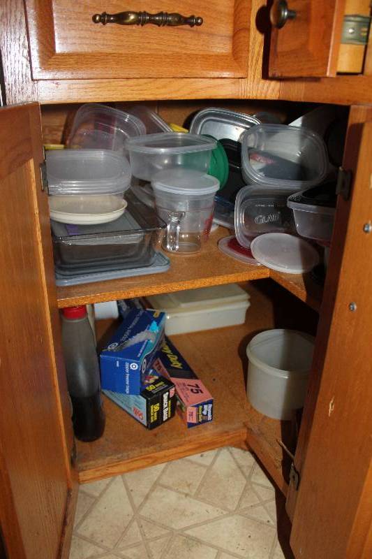 lot 185 image: Contents of Cupboard Includes Tupperware, Plastic Containers, Measuring Cup, Aluminum Foil, And More