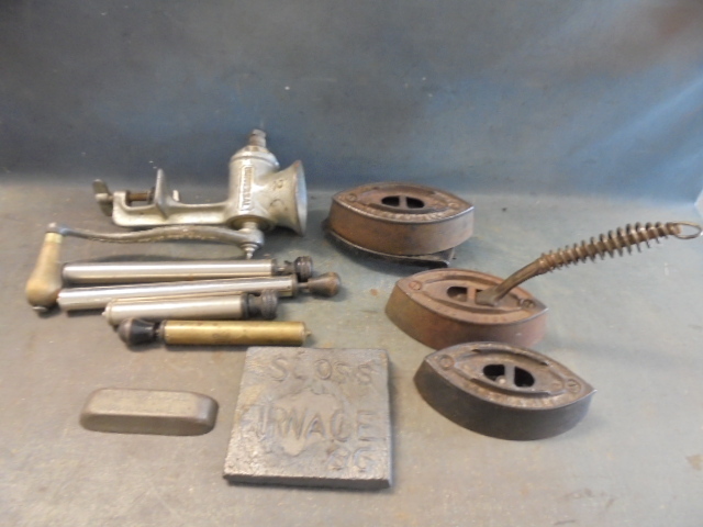 lot 171 image: Antique Irons, Meat Grinder and lamp Pumps