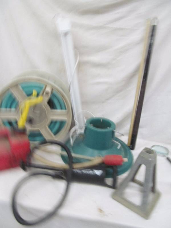 lot 194 image: hose and reel, gas can, tree stand, siphon pump