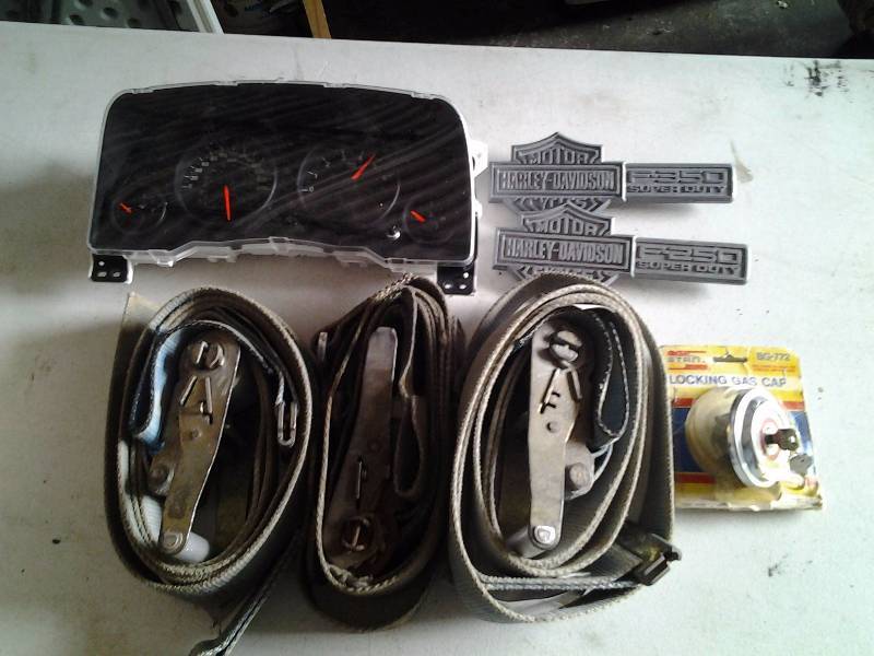 lot 37 image: 3-Ratchet Straps (2-E Track), 2 Harley Davidson Fender Emblems, Chrysler Instrument Cluster, Locking Gas Cap