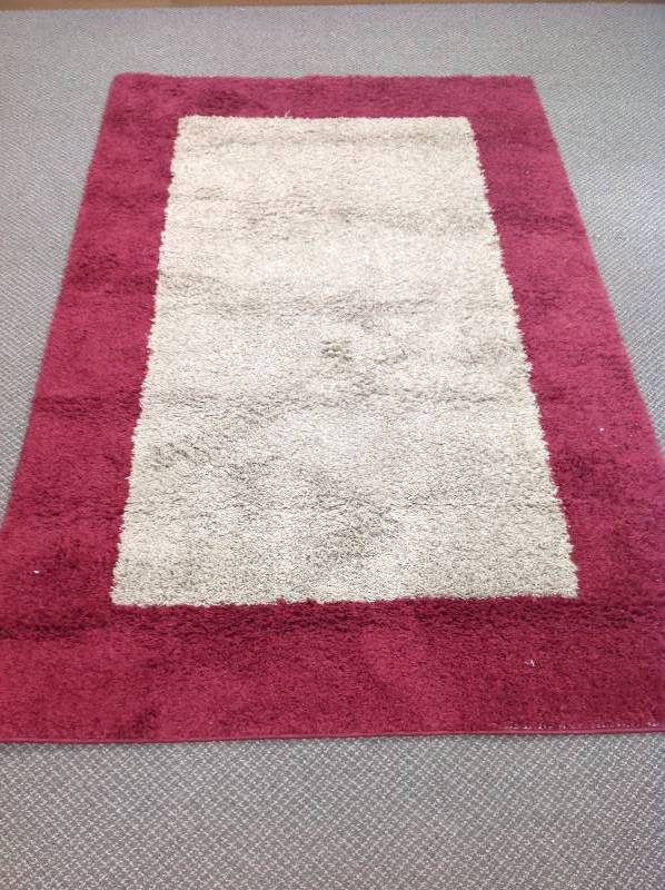 lot 56 image: Red and Tan Area Rug