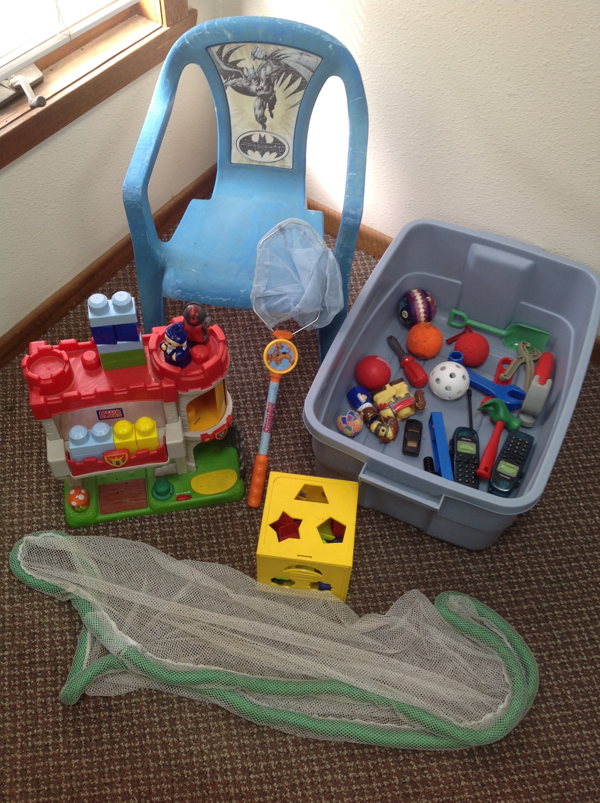 lot 28 image: Maga Blocks Castle, Tote of Toys, Butterfly Net, Toy Net, Doll, Batman Chair