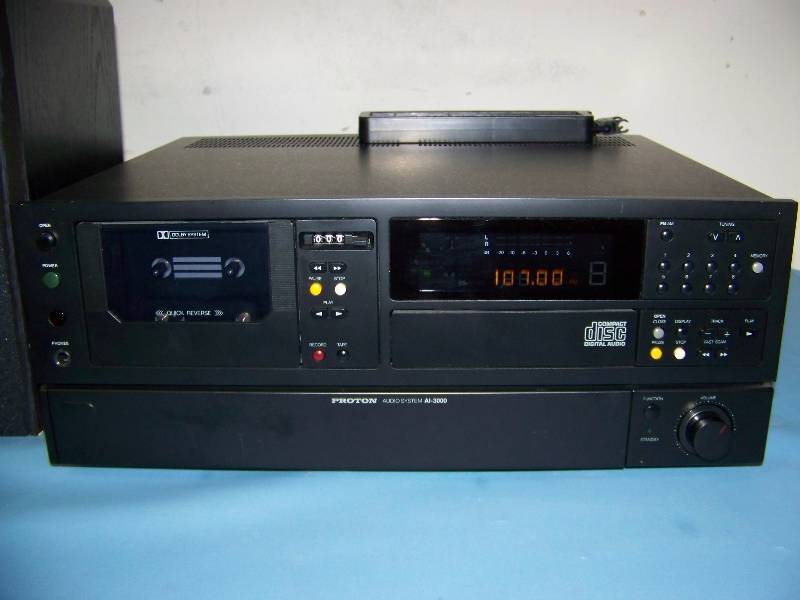 lot 41 image: Proton, AMFM Receiver  CD Player  Cassette Tape Deck with (2) Proton Loudspeakers  Speakers and Remote Control