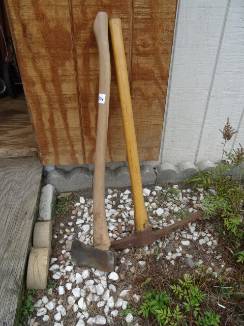 lot 134 image: Wooden axe and a pick axe...