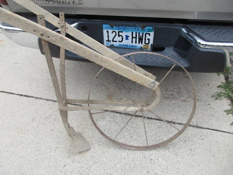 Antique tobaggons and planting wheel
