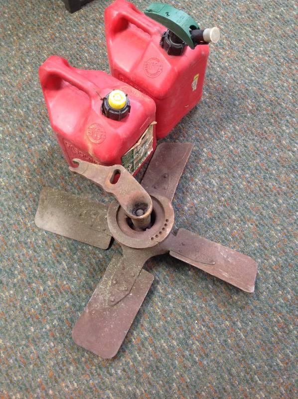 2 gas cans and steel fan wbelt pulley