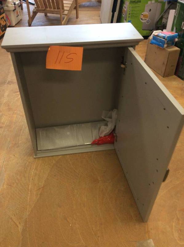 lot 115 image: Foremost Ashburn 23 in. W x 28 in. H x 8 in. D Framed Wood Surface-Mount Bathroom Medicine Cabinet in Grey damaged on the edge see pictures