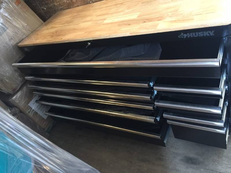 lot 107 image: Husky 66 in. W 24 in. D 12-Drawer Heavy-Duty Mobile Workbench, Black small dents on side and one doors need lock too see pictures not used