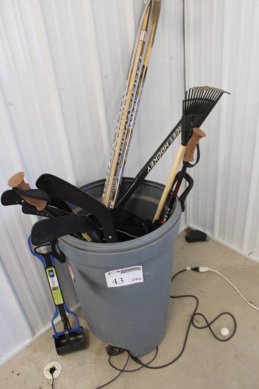 lot 43 image: Bin Lot of Hockey Sticks, Ski Poles, Lawn Rake