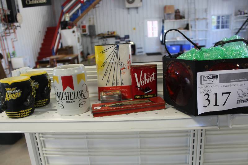 lot 317 image: Decorations And Collectibles Includes Mugs, Cans, And More