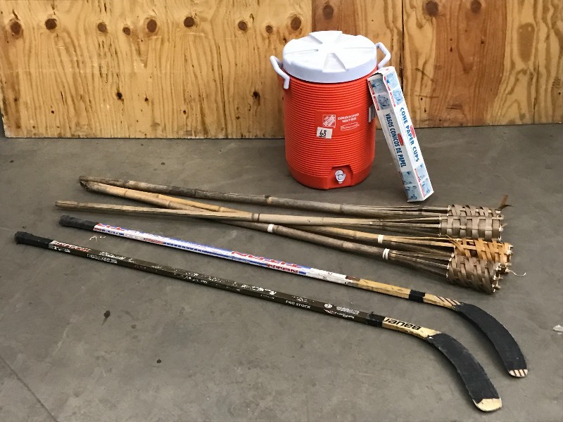 lot 68 image: Tiki Torches, Hockey Sticks, Drink Cooler
