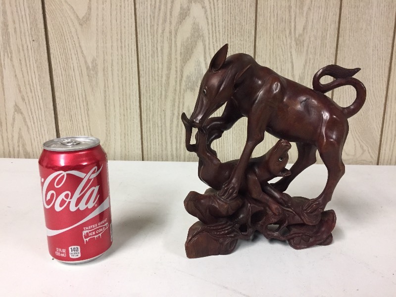 lot 45 image: Dog Eat Dog Wood Carved Sculpture