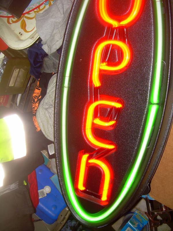 lot 1 image: OVAL SHAPED NEON SIGN
