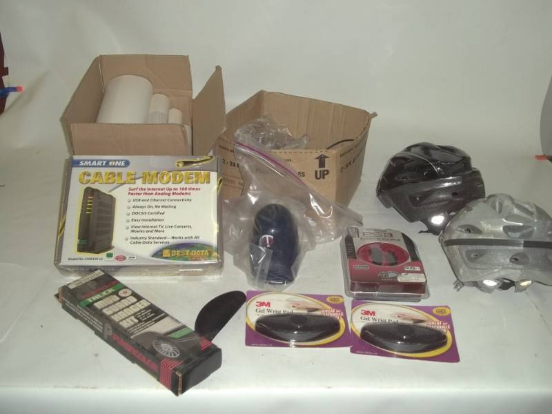 lot 247 image: Lot with Cable Modem, Bike Helmets, Mud guard hanger kit, Gel Wrist pad and ps3 power cable