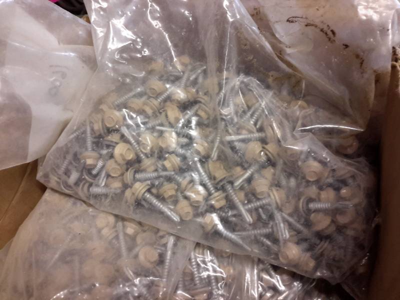 lot 132 image: Looks like about 6 bags of the self tapping screws with Hex head