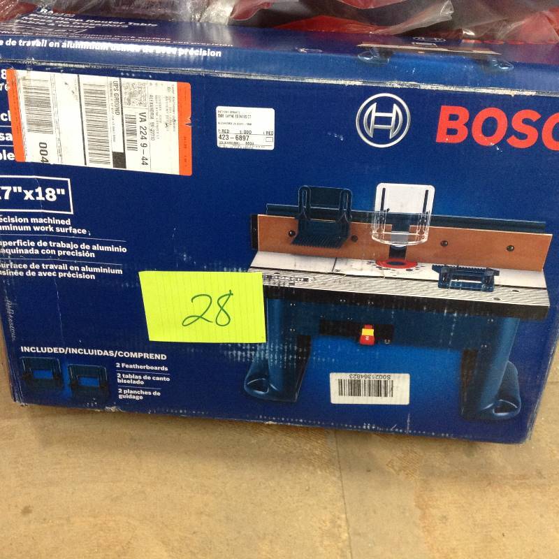lot 28 image: MSRP $199 Bosch used 15 Amp Corded 27 in. x 18 in. Aluminum Top Benchtop Router Table with 2-12 in. Vacuum Hose Port
