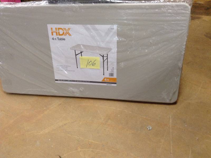 lot 106 image: 4 ft never used HDX Earth Tan Banquet Folding Table
